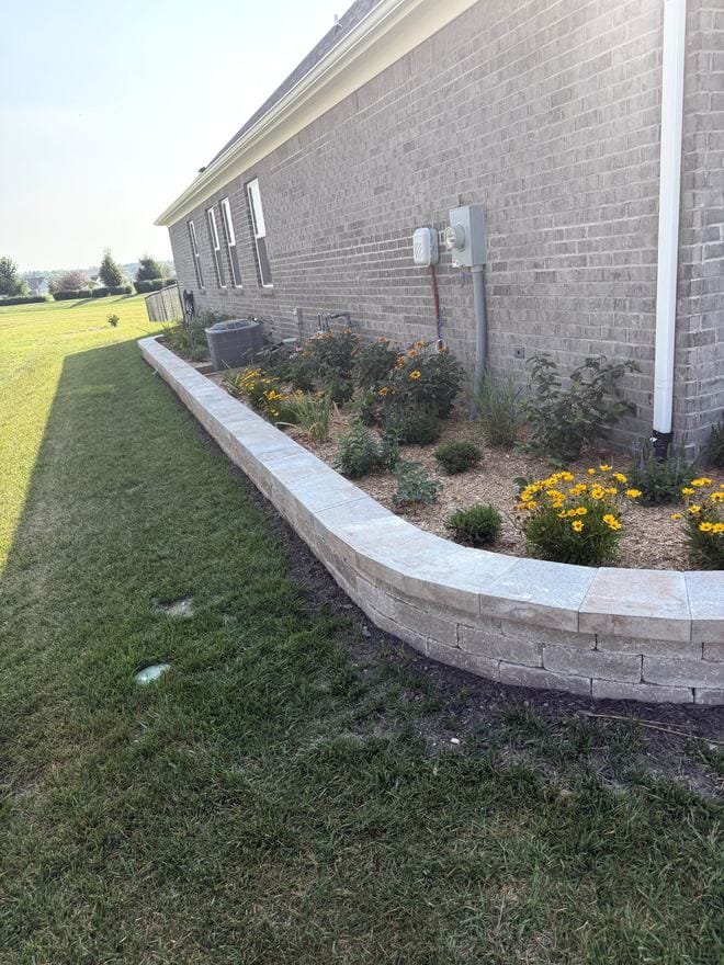 Curved block retaining wall with a landscape bed